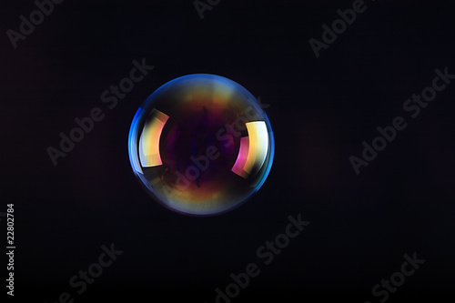 Soap bubbles on black background .