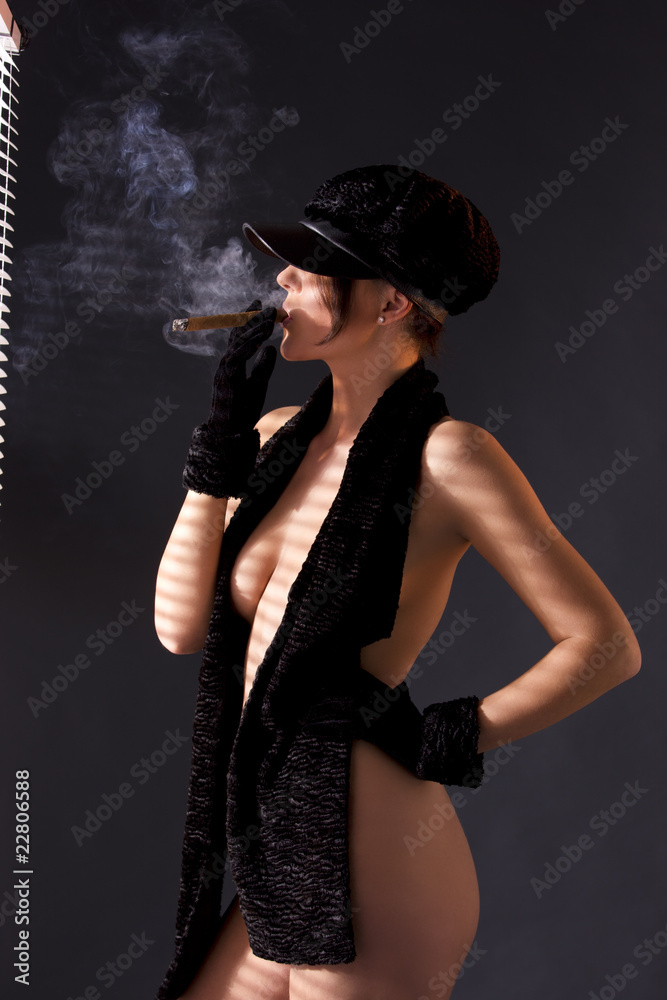 woman in black astrakhan smoking cigar