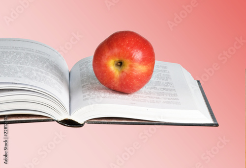 Red apple on open book