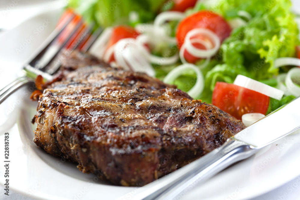 Steak with herbs and fresh vegetable salad