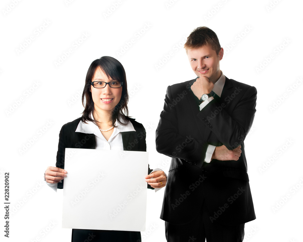 Smiling businesswoman and businessman with blank sign Smiling businesswoman and businessman with blank sign