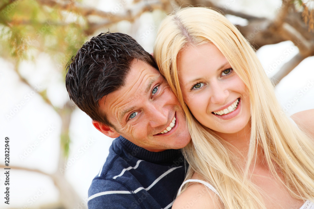 Young happy couple. Shallow DoF with focus on the woman.