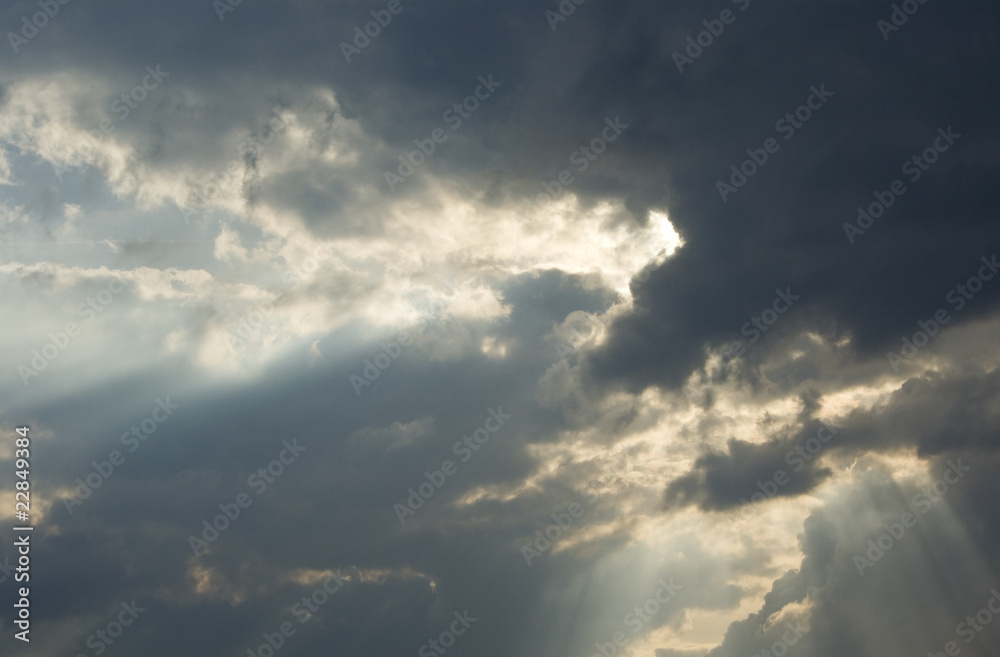 Big rays of light through grey clouds Big rays of light through grey clouds