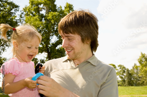 Young father playing with his daughter in the park