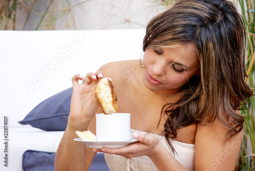 Portrait of young woman eating batch