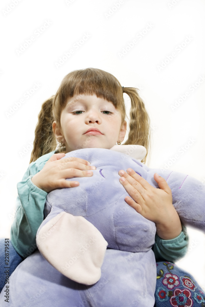 Little girl cuddling a stuffed elephant Little girl cuddling a stuffed elephant