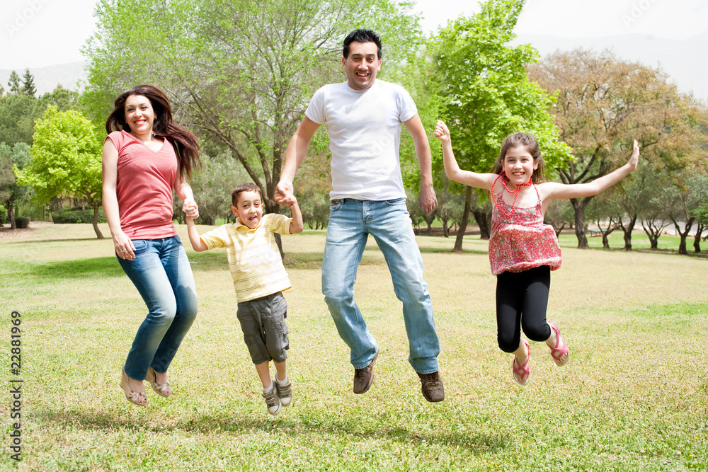 Family jumping together in the park