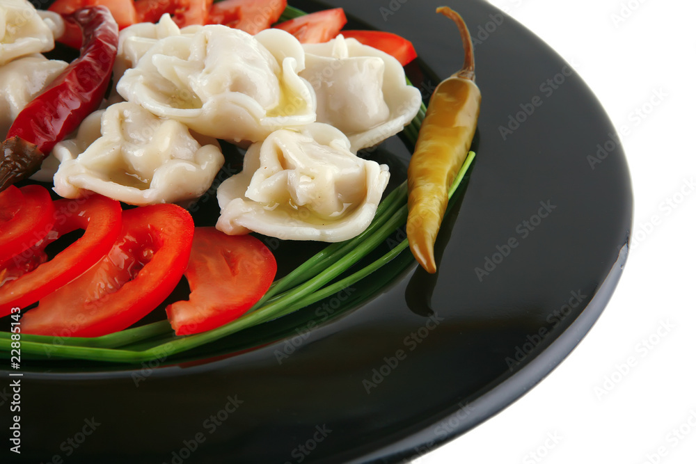 dumplings served on black plate