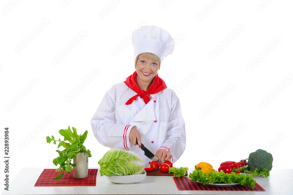 young girl cuts the tomatoes in the kitchen. young girl cuts the tomatoes in the kitchen.