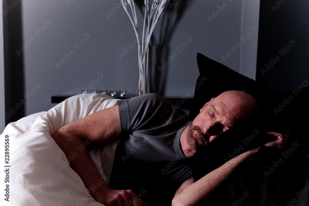Bald middle aged man sleeping