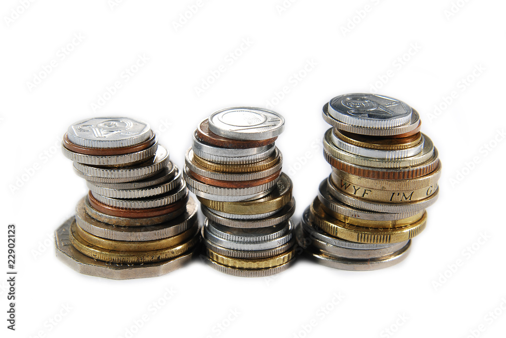 Three stacks of different coins on white background Three stacks of different coins on white background