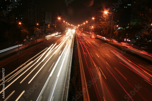 city by night:main roads with cars and reflections. .