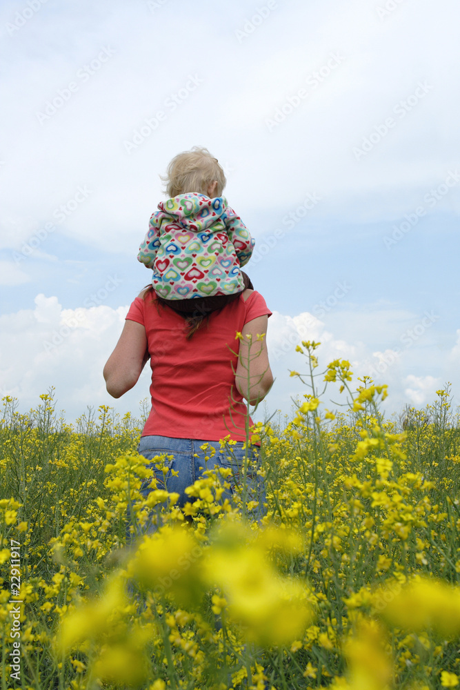 Fototapeta premium mother with child on a yellow field
