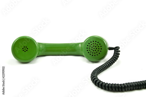 old telephone receiver with cord on white background