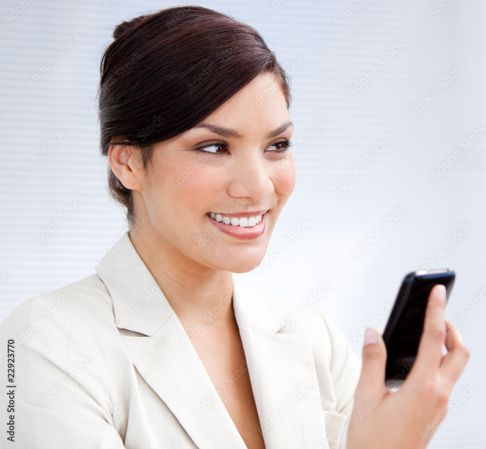 Radiant businesswoman using a mobile phone Radiant businesswoman using a mobile phone