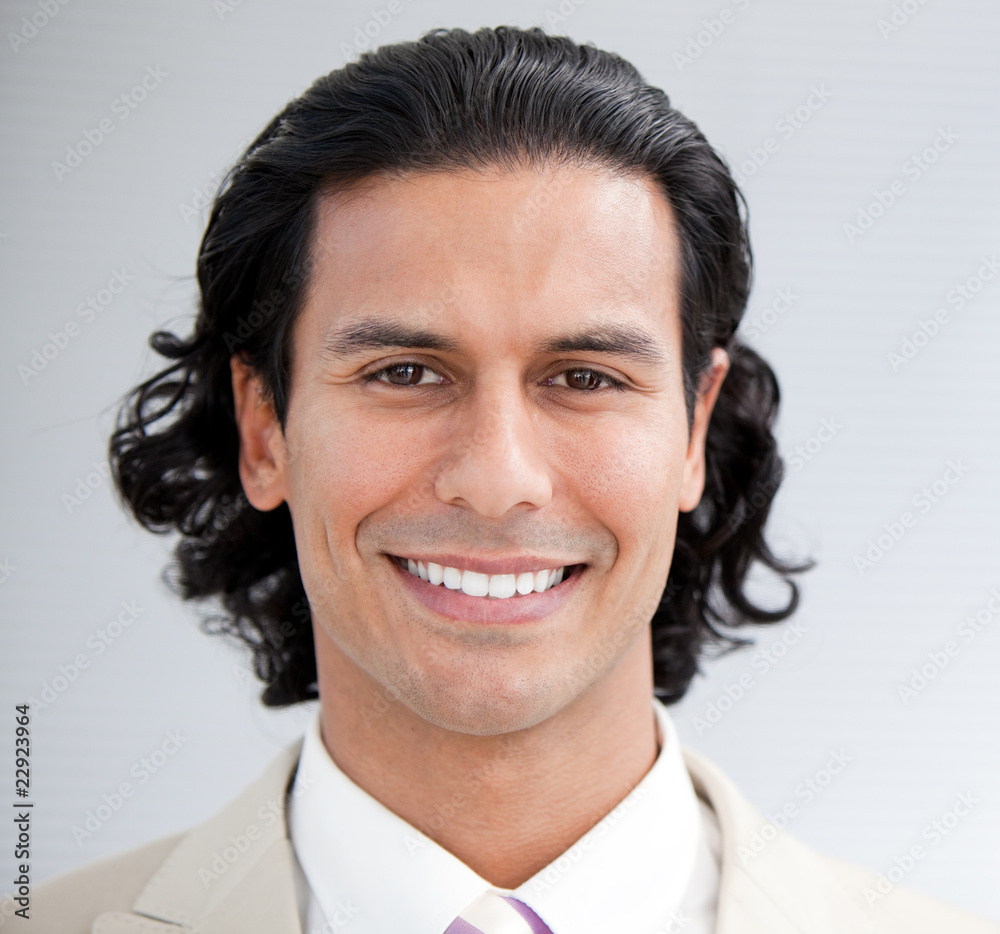Confident businessman smiling at the camera Confident businessman smiling at the camera