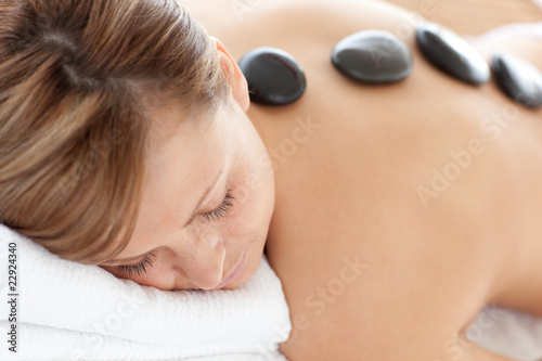 Close-up of a bright woman having a stone therapy