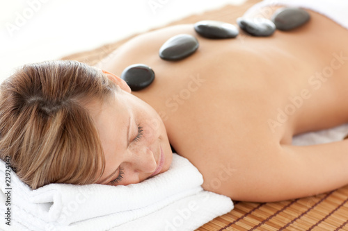 Bright woman having a stone therapy