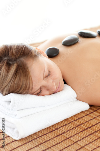Delighted woman having a stone therapy