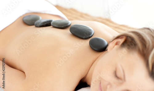 Relaxed woman with hot stones on her back