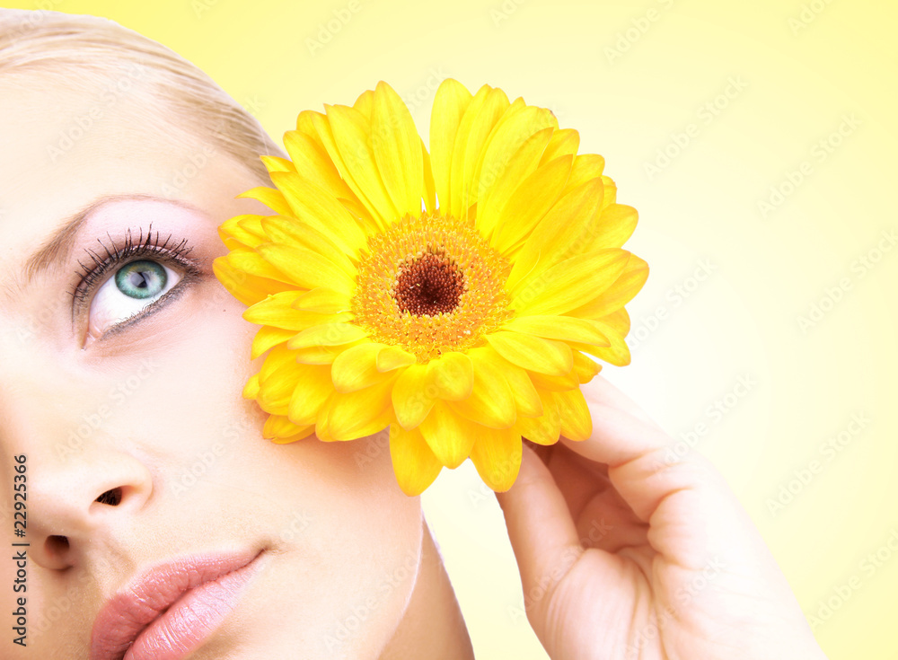 Beautiful young woman with gerber flower isolated