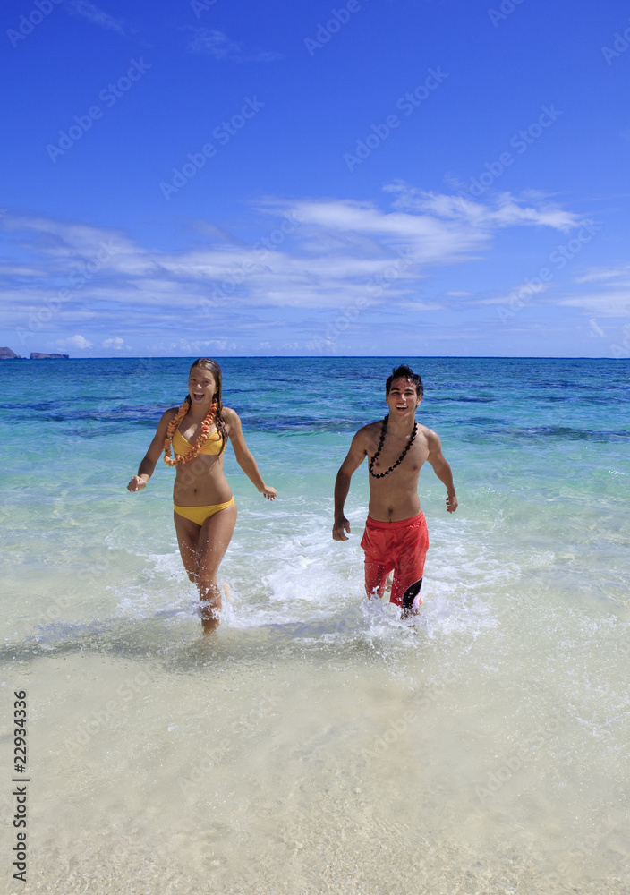 young couple comes out of the ocean