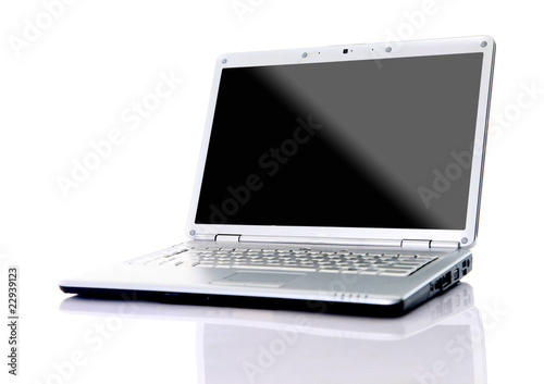 Modern laptop with reflections on glass table..