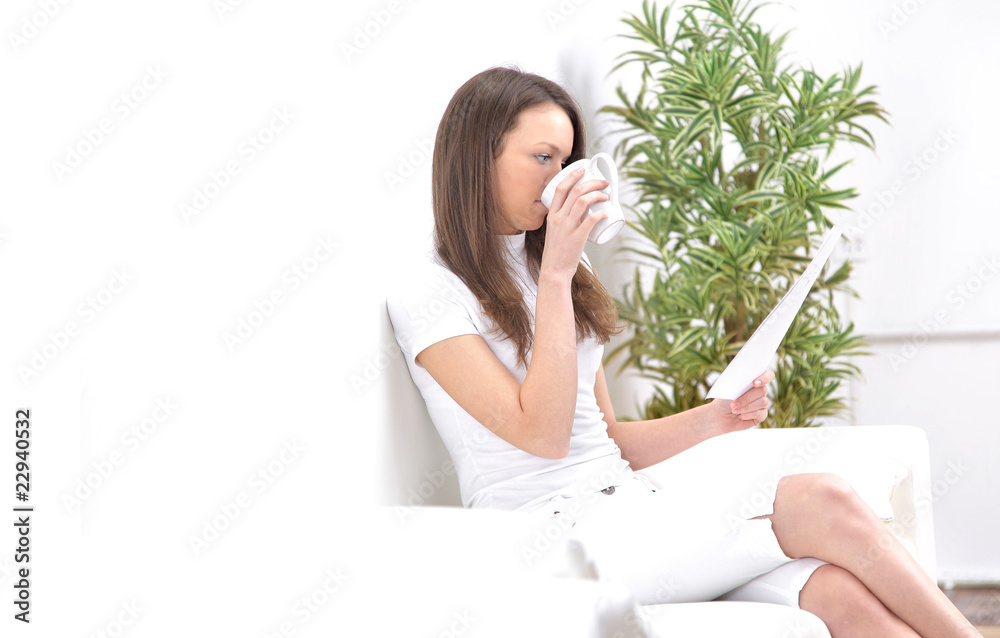 Portrait of happy young woman sitting on sofa Portrait of happy young woman sitting on sofa