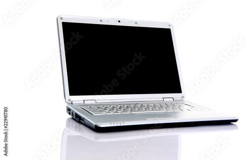 Modern laptop with reflections on glass table..