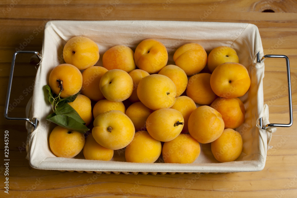 Apricots in a Basket on Wood