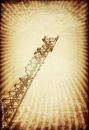 Grunge transmitter tower against sunburst image. photo