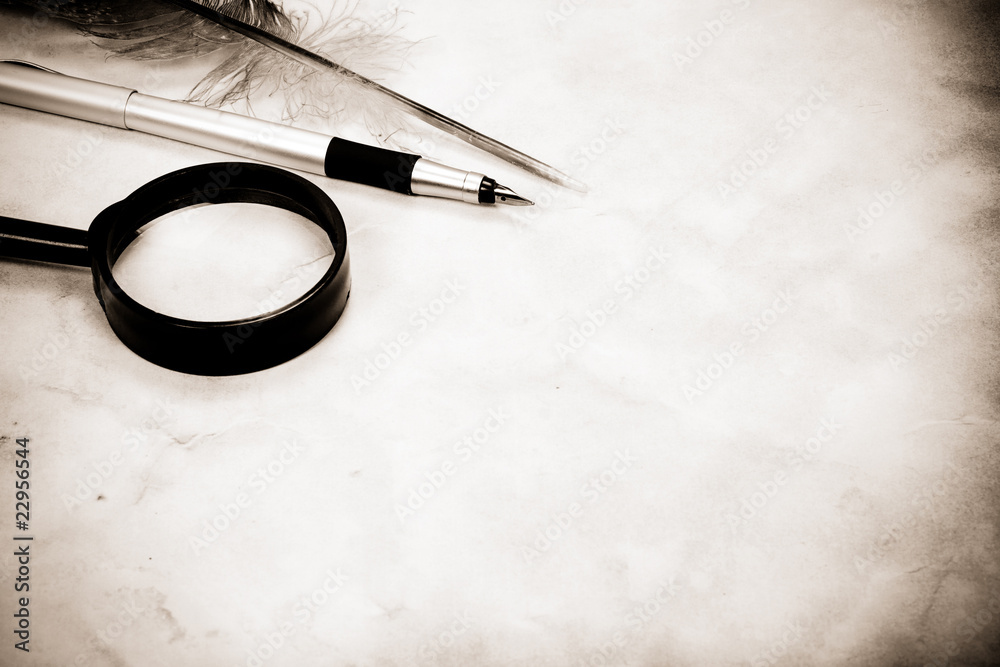 Fototapeta premium magnifying glass and pen