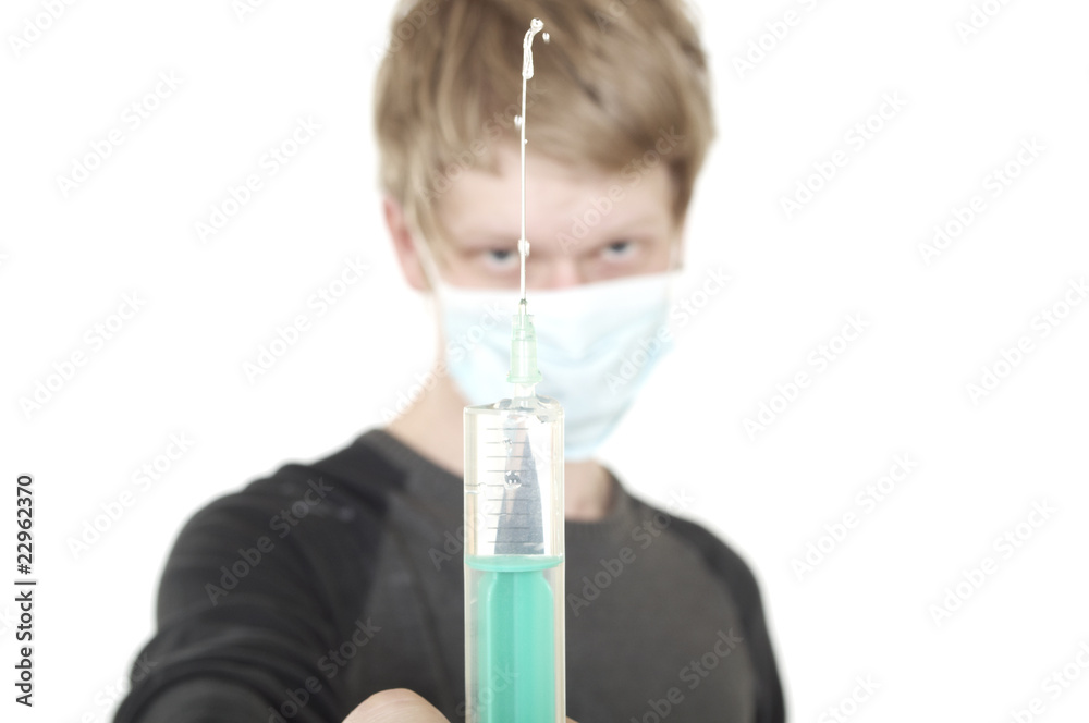 young man holding a syringe young man holding a syringe