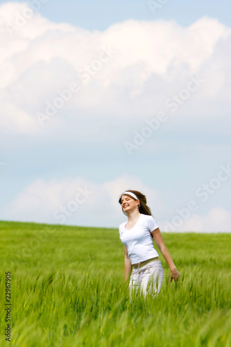 young happy girl in green grass