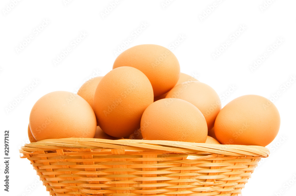 Brown eggs in the basket on white Brown eggs in the basket on white