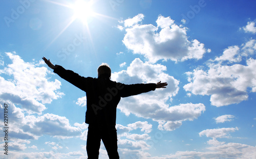 The happy young man and the solar sky