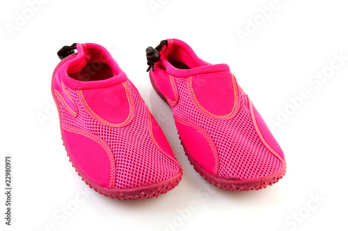 Pink water shoes over white background