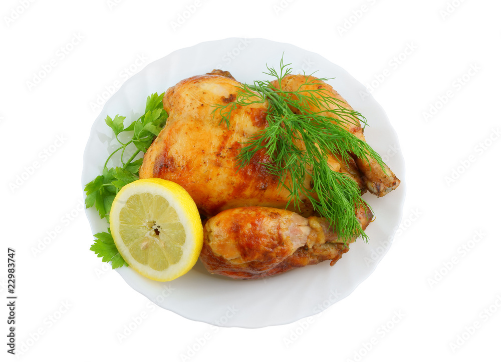 Grilled chicken with lemon and greens on plate isolated Grilled chicken with lemon and greens on plate isolated