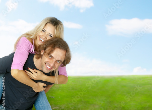 young man giving her woman piggyback ride