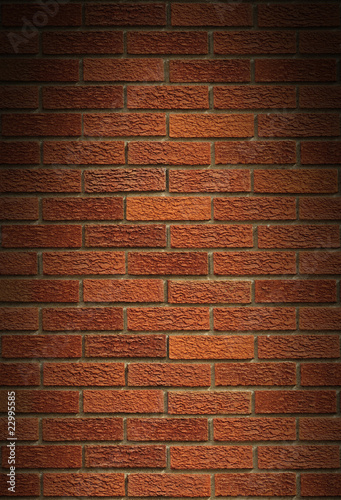 Red brick wall background lit from above
