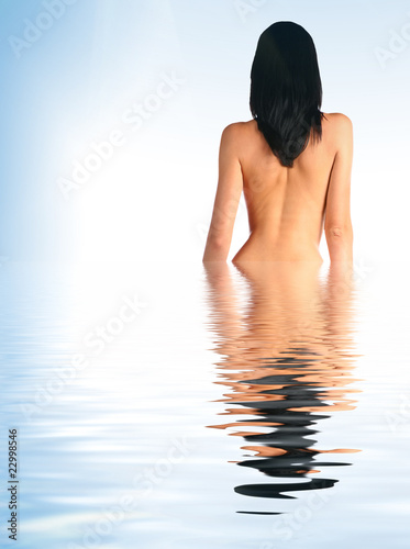 Beautiful young woman half in water photo