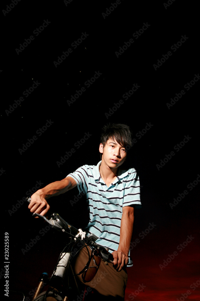 Fototapeta premium young asian man with bike