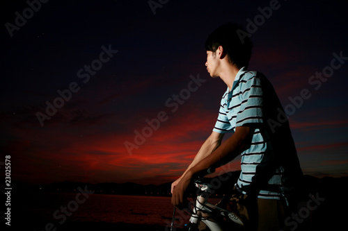 young asian man with bike