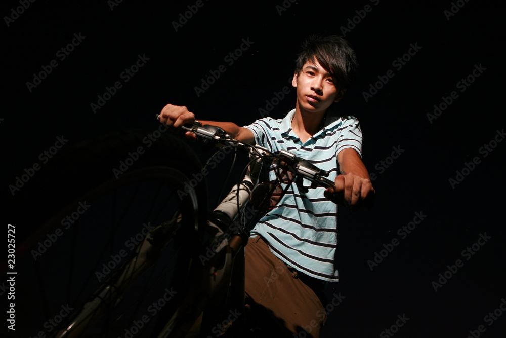 Fototapeta premium young asian man with bike