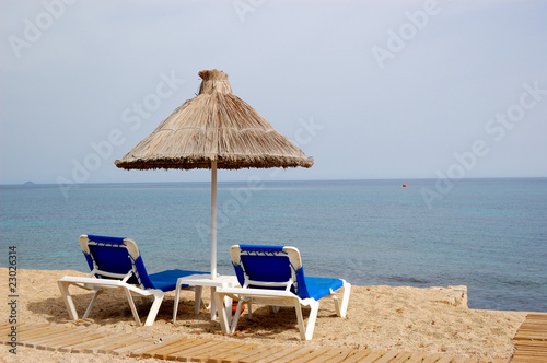 Beach and sunbeds of popular hotel  Crete  Greece