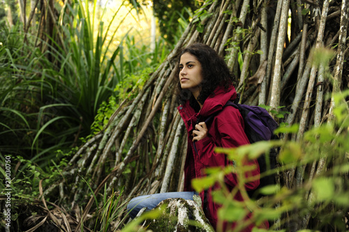 ecotourism: female hiker exploring wilderness of rainforest