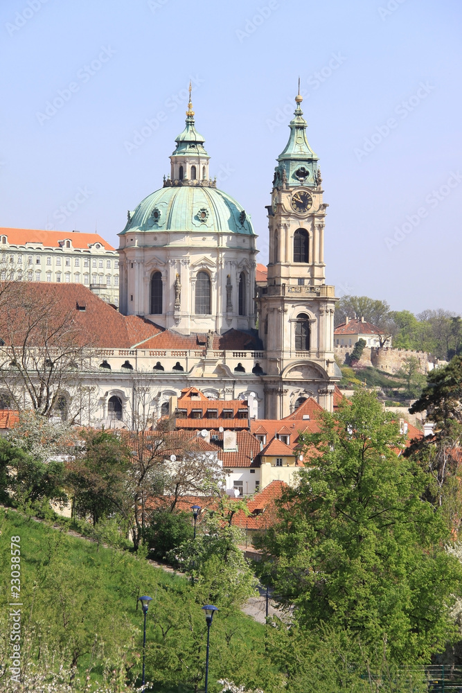 Prague's St. Nicholas' Cathedral with flowering trees