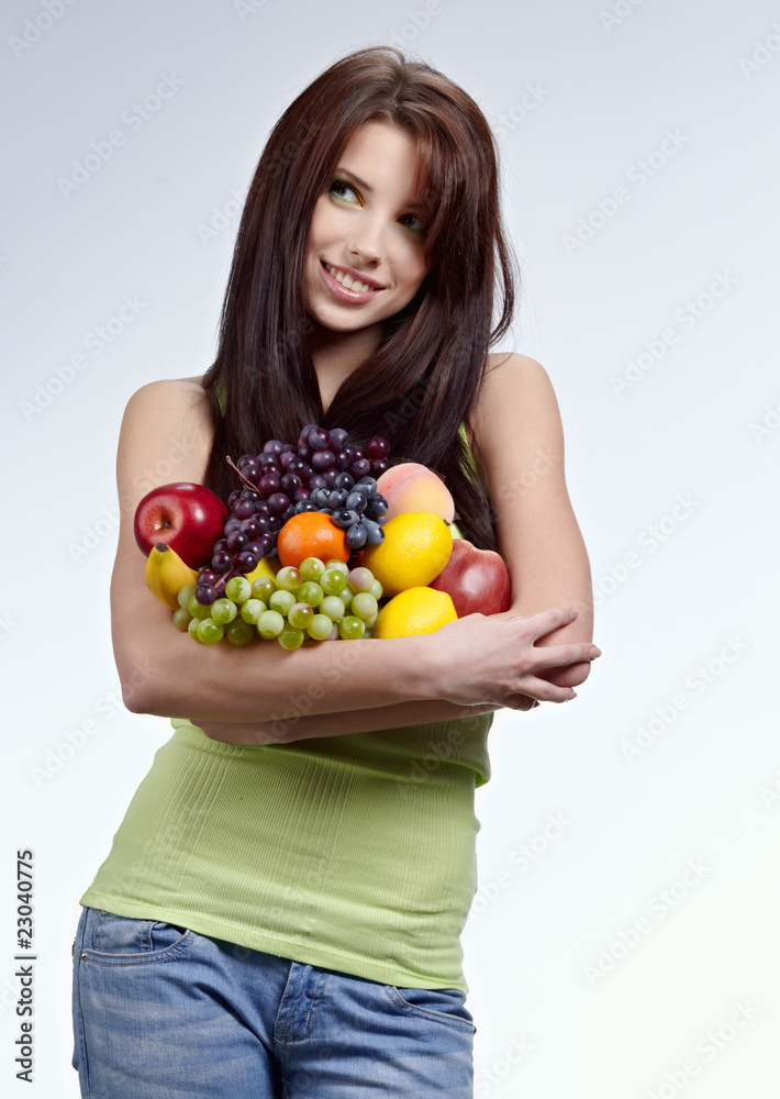 Woman with a shopping bag filled with nutritious fruit and veget Woman with a shopping bag filled with nutritious fruit and veget
