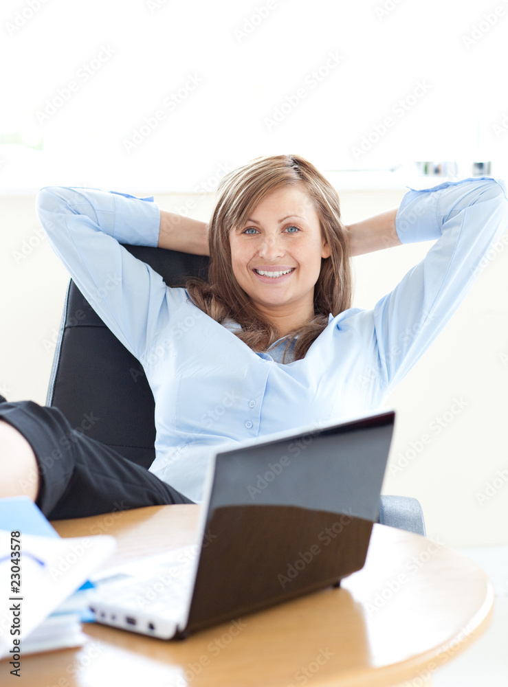 Smiling businesswoman looking at the laptop Smiling businesswoman looking at the laptop