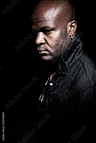 Black gangster men looking serious on a dark background